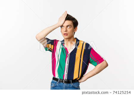 Annoyed gay man facepalm and roll eyes, standing disappointed and tired over white background 74125254