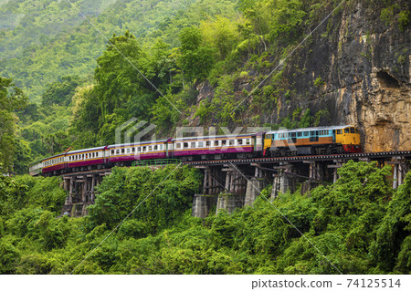 Train running on the death railway River Kwai in Kanchanaburi, Thailand. 74125514