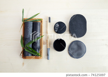 Bamboo charcoal eco friendly cosmetics products. Toothbrush and soap with skin cleansing 74125897