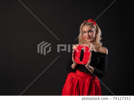 Girl holding the letters of the word LOVE love, Valentine's day design, on the floor hearts lovely space. the honeymoon form. copy space festive, black in red dress girl, barefoot Girl holding the letters of the word LOVE love, Valentine's day design, on the floor hearts lovely space. the honeymoon form. copy space festive, black in red dress girl, barefoot 74127351