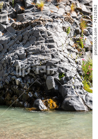 Basalt rocks and pristine water of Alcantara gorges in Sicily, Italy Basalt rocks and pristine water of Alcantara gorges in Sicily, Italy 74128362
