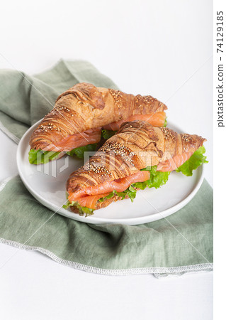 Croissant Sandwich with salmon and salad leaves Croissant Sandwich with salmon and salad leaves 74129185