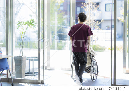 Caregiver helper elderly senior wheelchair walk Caregiver helper elderly senior wheelchair walk 74131441