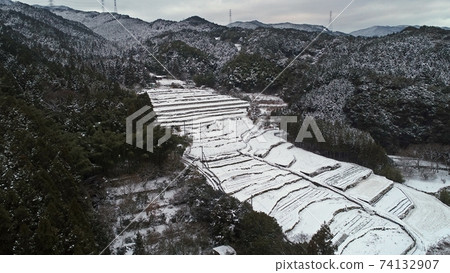 Snow-covered stone rice terraces and Sefuri mountain range Snow-covered stone rice terraces and Sefuri mountain range 74132907
