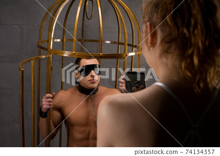 Couple with smartphone playing erotic BDSM game 74134357