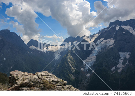 Panorama of mountains scene with dramatic blue sky in national park of Dombay 74135663