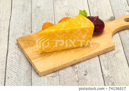 Marble cheese triangle over wooden Marble cheese triangle over wooden 74136817