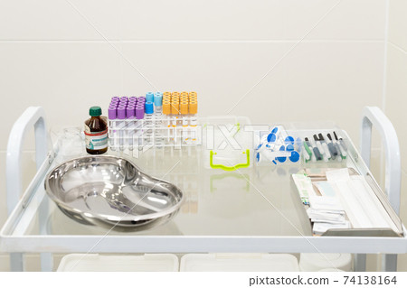 Blood tubes in tray in medical lab. Empty blood tube tests ready for analysis in the laboratory of haematology. Blood tubes in tray in medical lab. Empty blood tube tests ready for analysis in the laboratory of haematology. 74138164