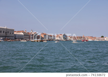 Panoramic view of Venice coast with historical buildings and Laguna Veneta Panoramic view of Venice coast with historical buildings and Laguna Veneta 74138672