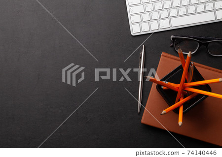 Office desk with supplies and glasses 74140446