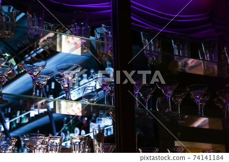 Glass goblets on a shelf in a bar Glass goblets on a shelf in a bar 74141184