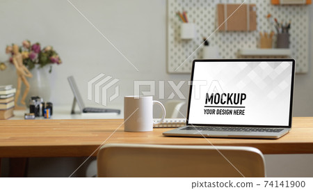 Close up view of office room with laptop, mug and copy space on the table Close up view of office room with laptop, mug and copy space on the table 74141900