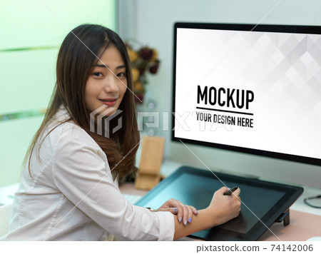 Businesswoman working with drawing tablet and computer in office room Businesswoman working with drawing tablet and computer in office room 74142006