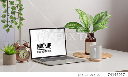 Biophilia workspace with laptop, cup, decorations and plant vase in home office room Biophilia workspace with laptop, cup, decorations and plant vase in home office room 74142037