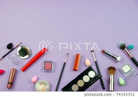 lots of makeup on a purple background lots of makeup on a purple background 74143352
