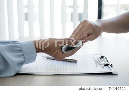 The owner's business offers and gives money to his partners for bribery and corruption. The concept of bribery and corruption The owner's business offers and gives money to his partners for bribery and corruption. The concept of bribery and corruption 74144521
