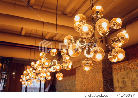 Beautiful chandelier. Modern chandelier hanging under ceiling. 74146087