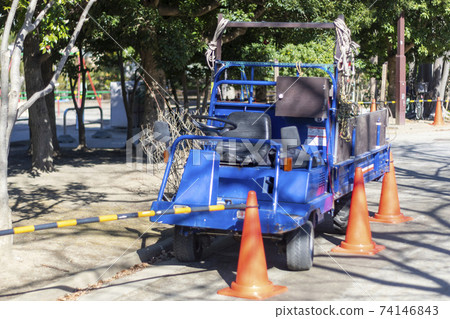 Blue work car in the park 74146843