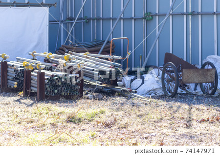 Material storage area: Stacked iron pipes and rear car Material storage area: Stacked iron pipes and rear car 74147971