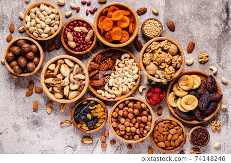 Various Nuts and dried fruits in wooden bowls. Various Nuts and dried fruits in wooden bowls. 74148246
