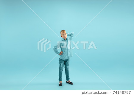 Childhood and dream about big and famous future. Pretty little boy isolated on blue background Childhood and dream about big and famous future. Pretty little boy isolated on blue background 74148797