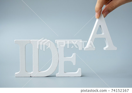 Businessman hand holding wooden IDEAS text on gray background. New Creative, Innovation, Imagination, inspiration, Solution, Strategy and GOAL concept Businessman hand holding wooden IDEAS text on gray background. New Creative, Innovation, Imagination, inspiration, Solution, Strategy and GOAL concept 74152167