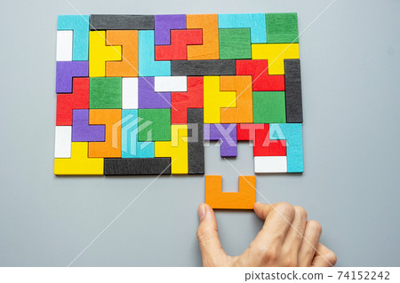 hand connecting geometric shape block with colorful wood puzzle pieces. logical thinking, business logic, Conundrum, decision, solutions, rational, mission, success, goals and strategy concepts hand connecting geometric shape block with colorful wood puzzle pieces. logical thinking, business logic, Conundrum, decision, solutions, rational, mission, success, goals and strategy concepts 74152242