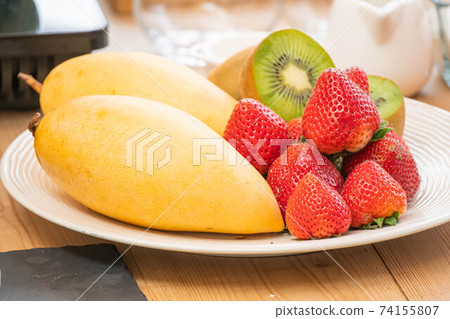mixed fresh fruits (strawberry, raspberry, blueberry, kiwi, mango) on wood bowl mixed fresh fruits (strawberry, raspberry, blueberry, kiwi, mango) on wood bowl 74155807