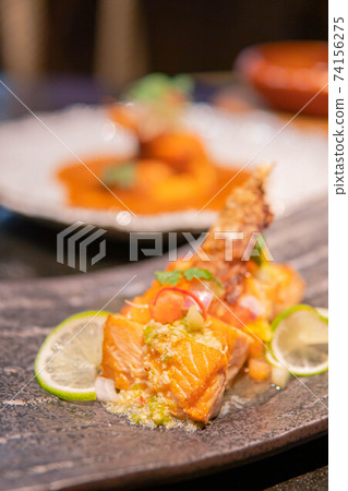 Fried salmon fillet with lemon and basil. 74156275