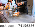 Hand of Chef cooking salmon steak 74156286