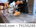 Hand of Chef cooking salmon steak 74156288