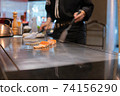 Hand of Chef cooking salmon steak 74156290
