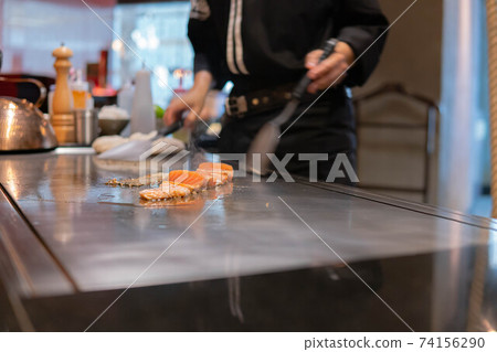 Hand of Chef cooking salmon steak Hand of Chef cooking salmon steak 74156290