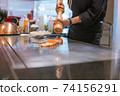 Hand of Chef cooking salmon steak 74156291