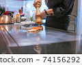 Hand of Chef cooking salmon steak 74156292