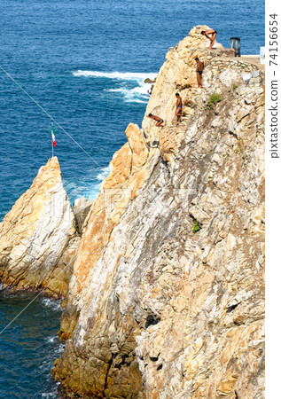 Cliff Divers jump at La Quebrada - Acapulco - Mexico Cliff Divers jump at La Quebrada - Acapulco - Mexico 74156654