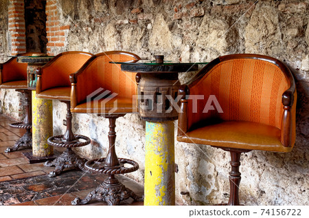Table and chairs setup in a traditional bar in Antigua Table and chairs setup in a traditional bar in Antigua 74156722