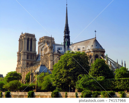 Notre Dame Cathedral in the fresh green season with a spire shining in the blue sky 74157966