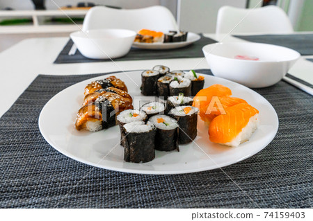 Fresh sushi and rolls in a white plate. Sushi lunch 74159403