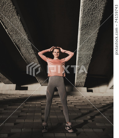 beautiful fitness woman stands in the city. beautiful fitness woman stands in the city. 74159743