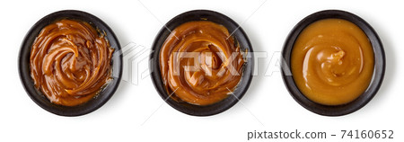 Caramel sauce in round dish isolated on white background Caramel sauce in round dish isolated on white background 74160652