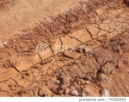 Mudlands that previously contained water have cracked due to hot weather and drought. All water content has been evaporated by the heat 74160893