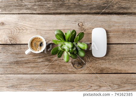 Coffee cup, computer mouse and succulent on wooden desk. Office desktop concept 74162385