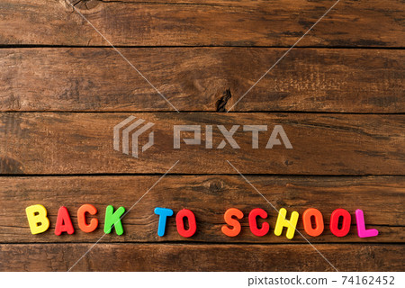 Back to school. Colourful text on retro wooden background with copyspace Back to school. Colourful text on retro wooden background with copyspace 74162452