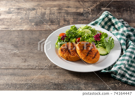 Delicious healthy chickpea burger and salad 74164447