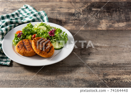 Delicious healthy chickpea burger and salad 74164448