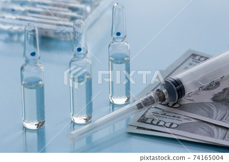 Three ampullas, syringe and paper money. Three ampullas, syringe and paper money. 74165004