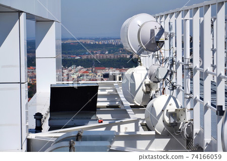 Construction for 5G broadband cellular network transmitters, telecommunication tower, wireless communication concept, clear blue sky background with copy space Construction for 5G broadband cellular network transmitters, telecommunication tower, wireless communication concept, clear blue sky background with copy space 74166059