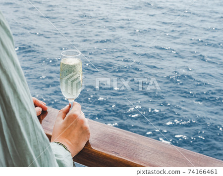 Beautiful glass with a drink on the background of sea 74166461