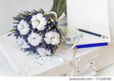 Lavender flowers and Cotton plant on vintage suitcase, open card for text. Natural Romantic eco gift Lavender flowers and Cotton plant on vintage suitcase, open card for text. Natural Romantic eco gift 74166486